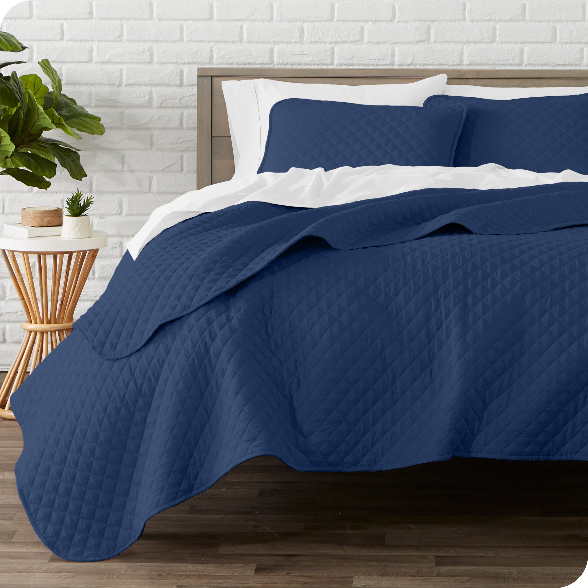 A quilted coverlet set on a bed