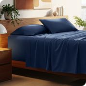 A cozy bedroom featuring a neatly made bed with soft, microfiber sheets