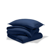 A comforter folded with a matching pillow sham stacked on top