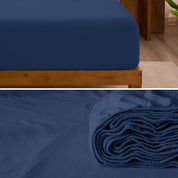 A divided image showing both the corner of a bed with organic jersey sheet and the folded sheet stacked on the bed.