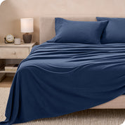 View of fleece sheets from the end of a bed with the top sheet draped over the side and end
