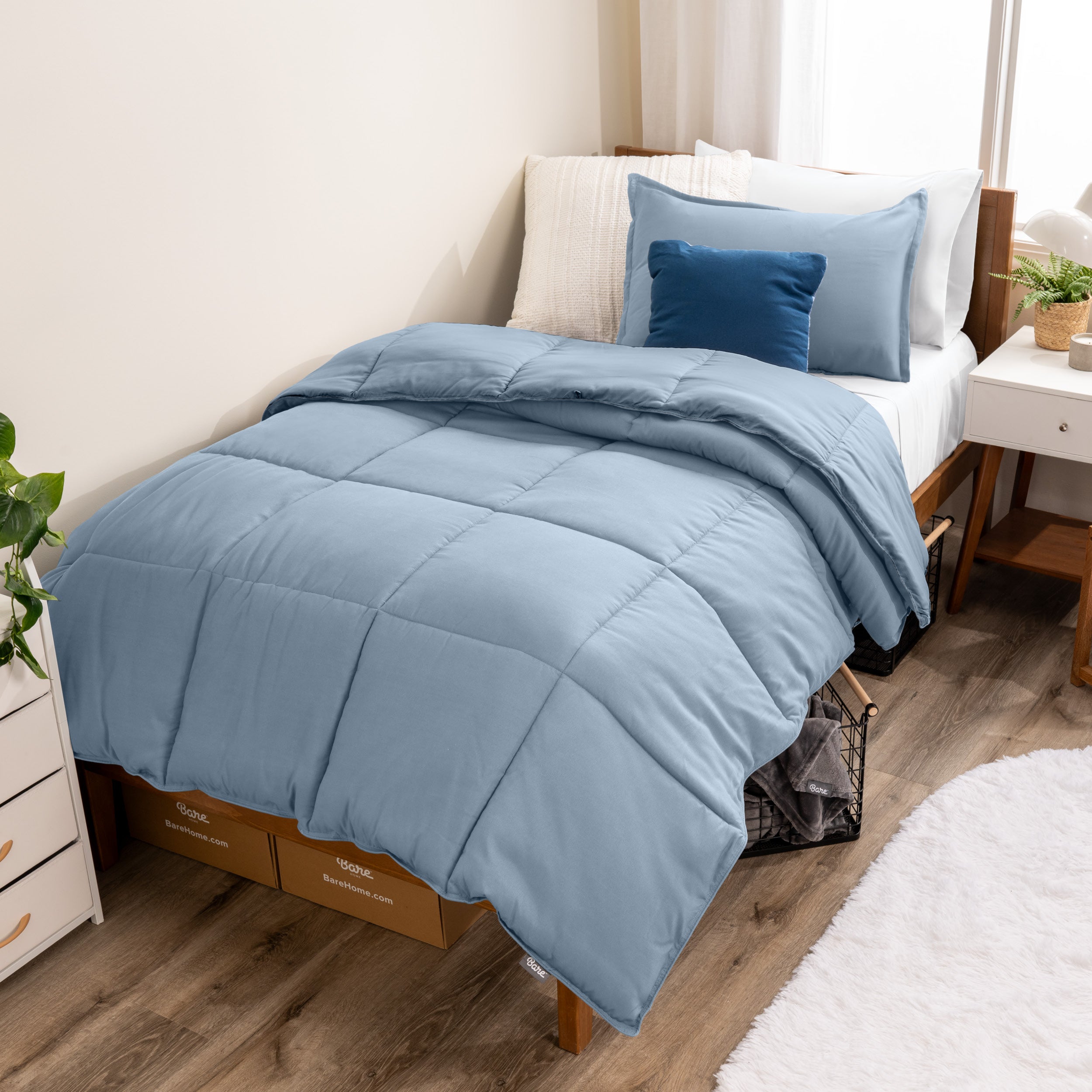 A modern bed with a down alternative comforter set on it