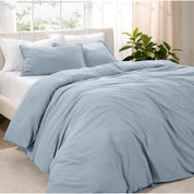 Angled view of bed with a duvet cover folded over on itself