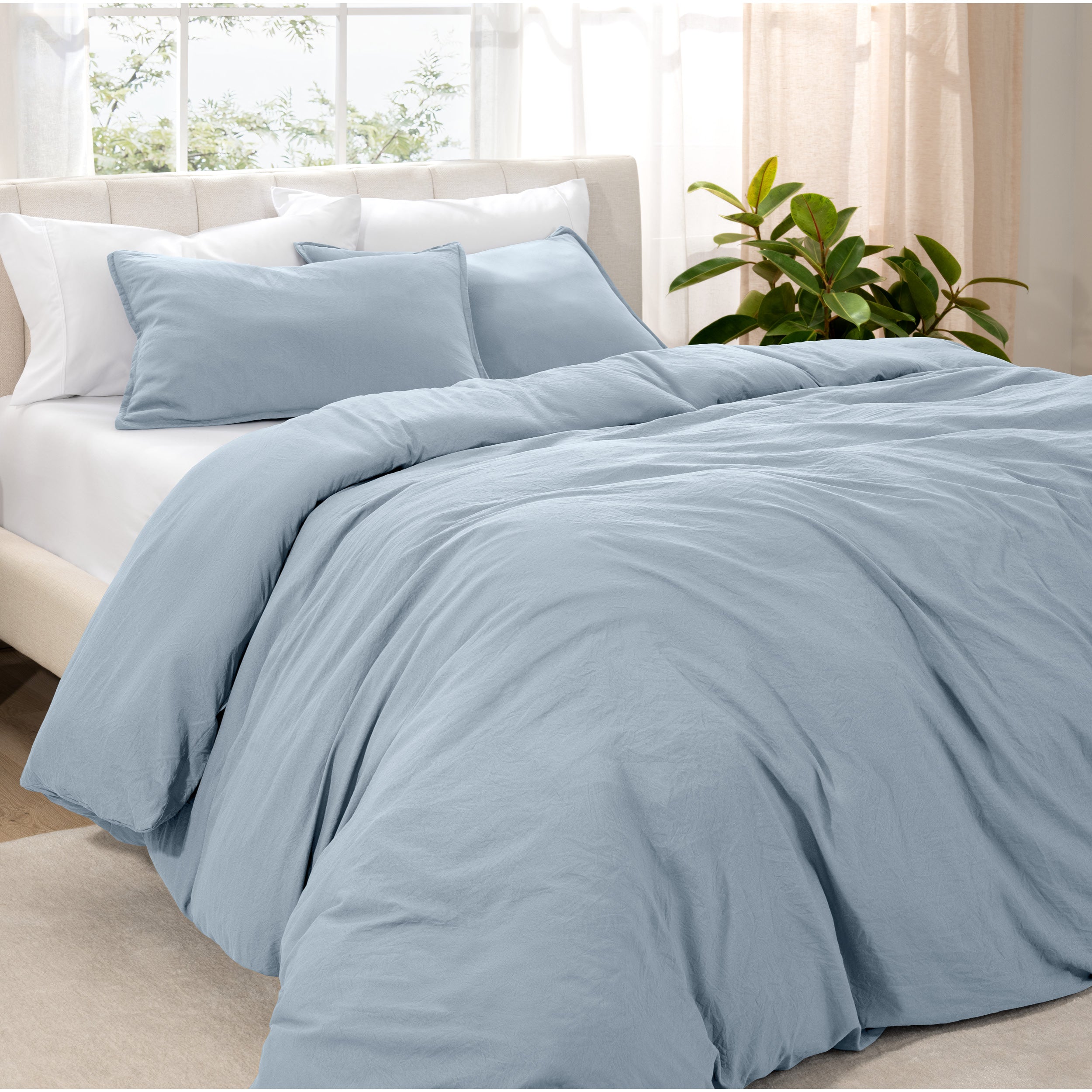 Angled view of bed with a duvet cover folded over on itself