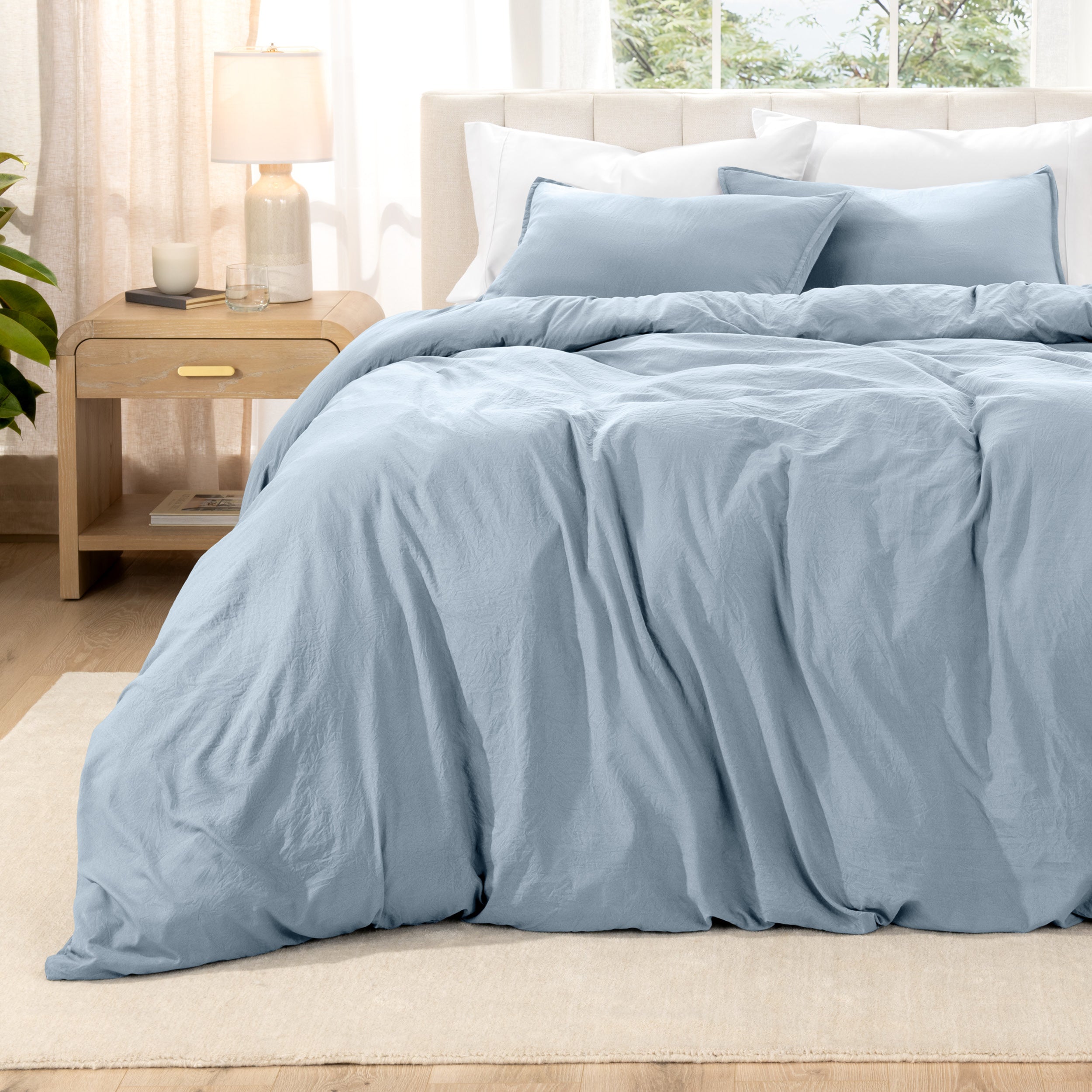 Relaxing room scene with a duvet cover laid out over the bed