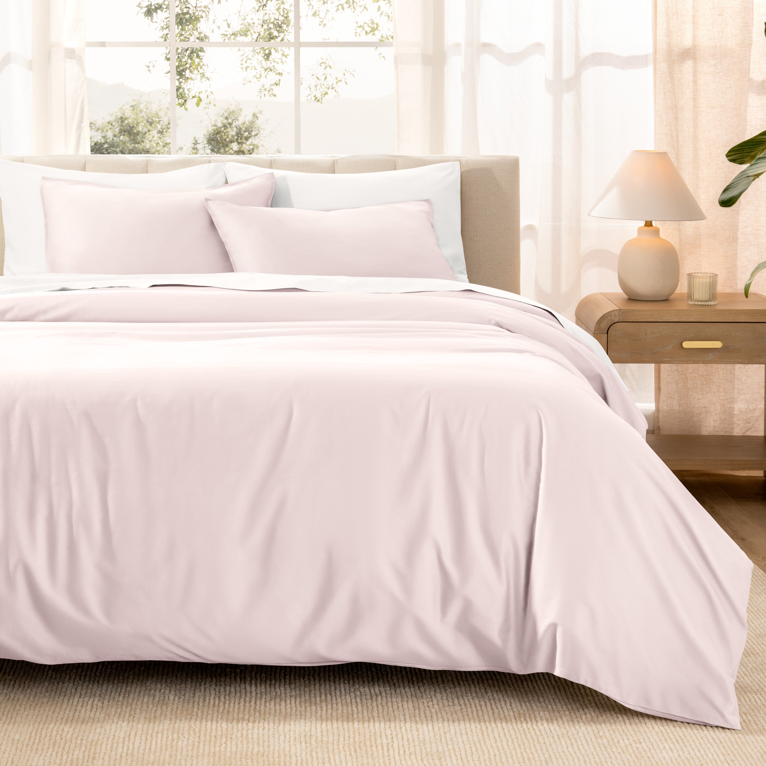 Warm bright room scene showing Sateen Duvet Set  laid out over the bed