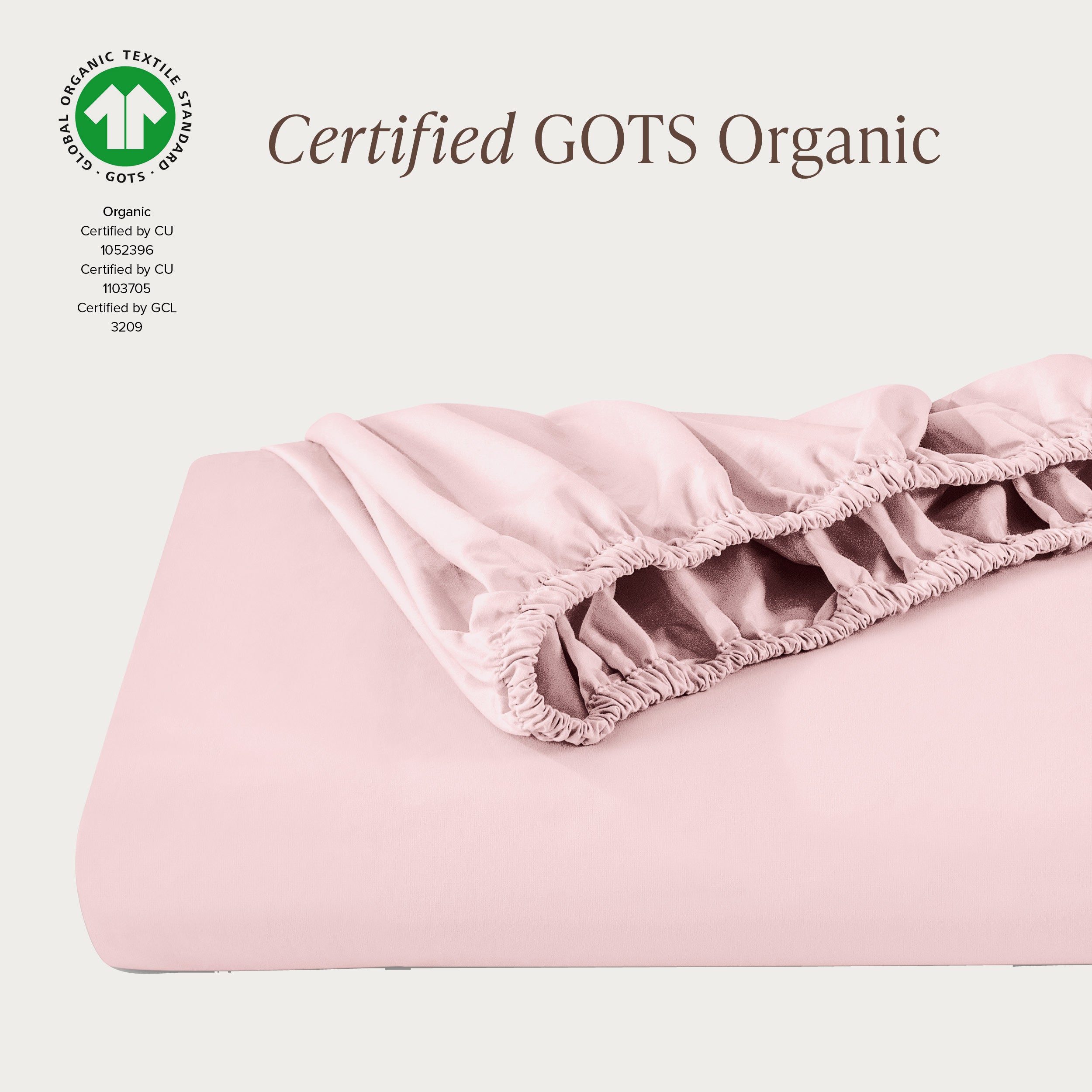 A single fitted sheet folded neatly showing part of the elastic. The fitted sheet is Certified GOTS Organic.