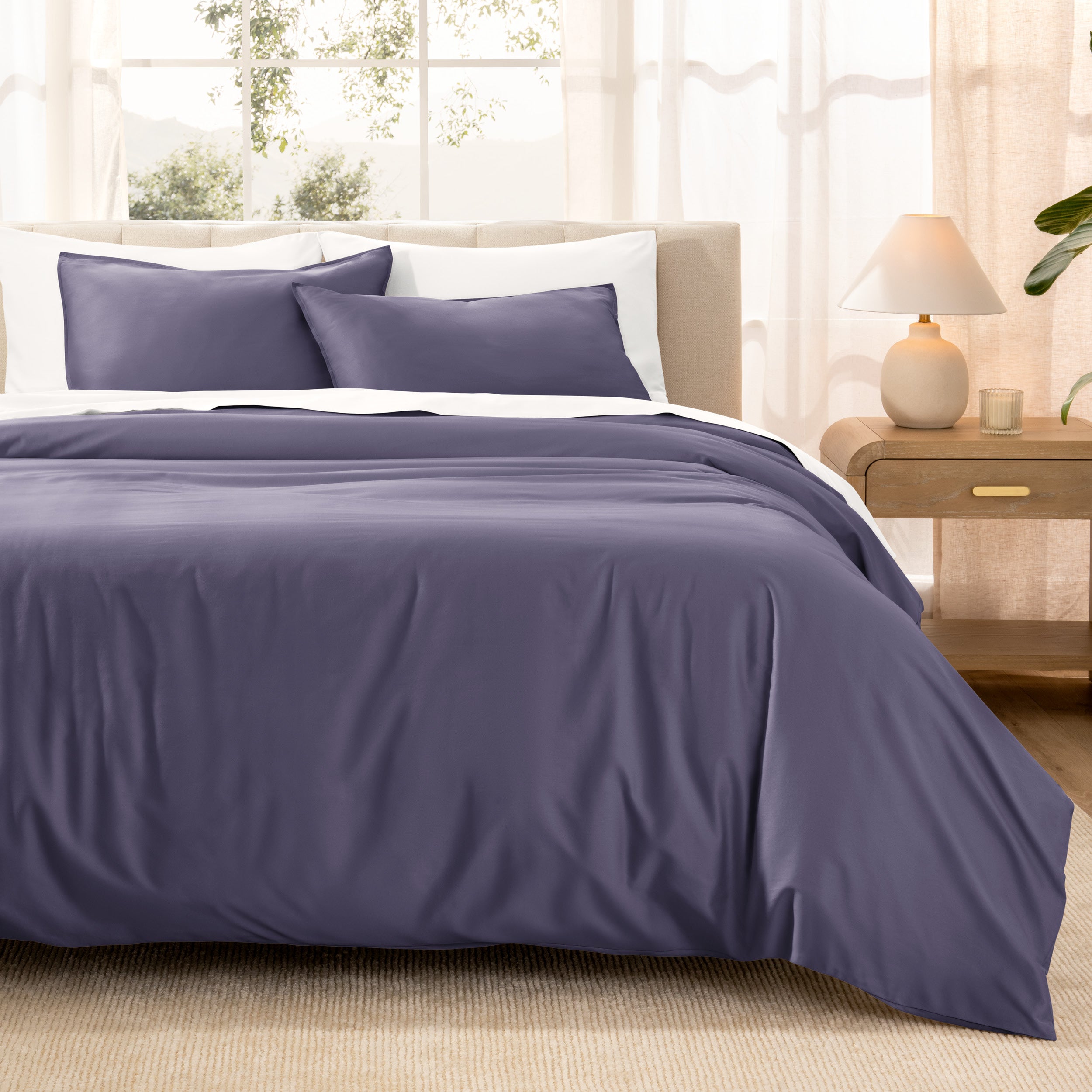 Warm bright room scene showing Sateen Duvet Set  laid out over the bed