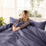 A modern bed with a sateen duvet cover set consisting of the duvet cover and two pillows.