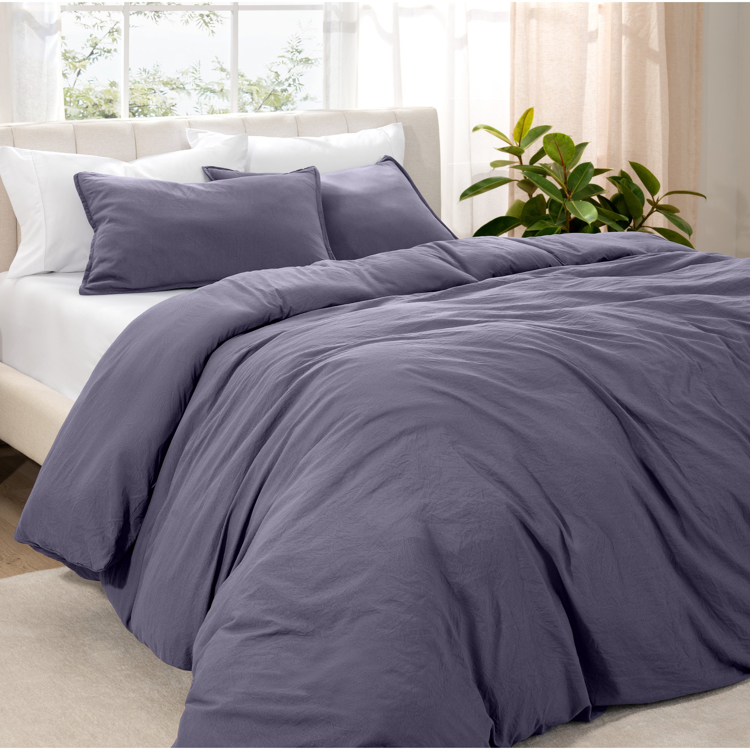 Angled view of bed with a duvet cover folded over on itself