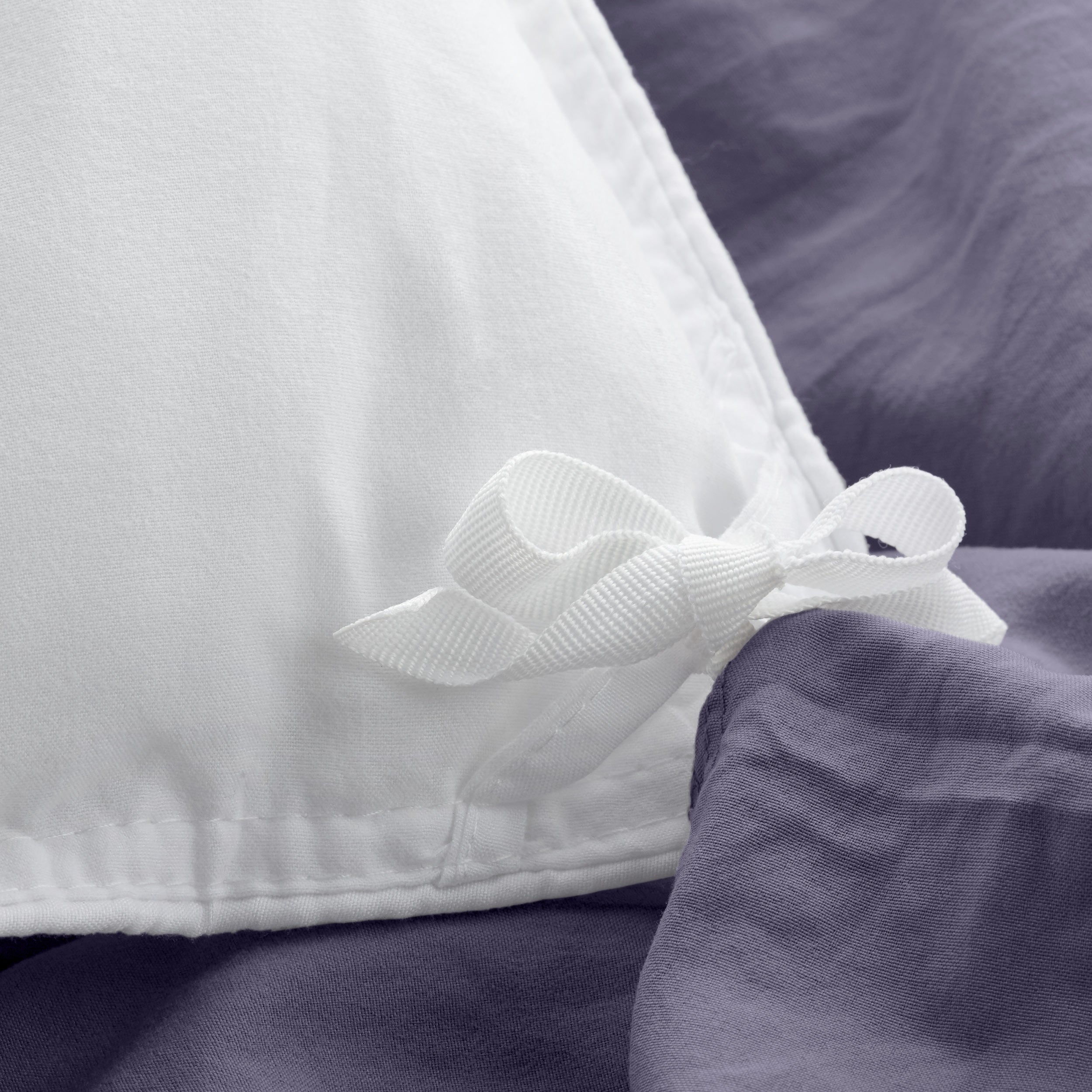 Close up of cloth ties for attaching duvet insert to inside of duvet cover