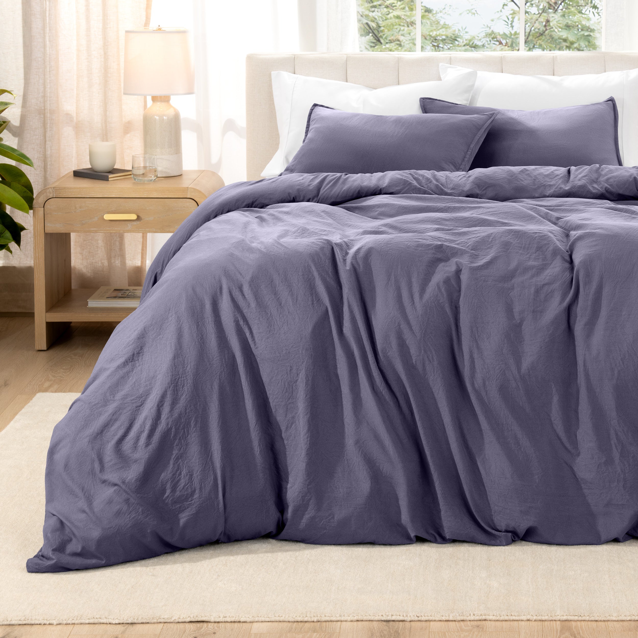 Relaxing room scene with a duvet cover laid out over the bed