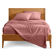 Microfiber sheet set on a bed with a wooden bed frame