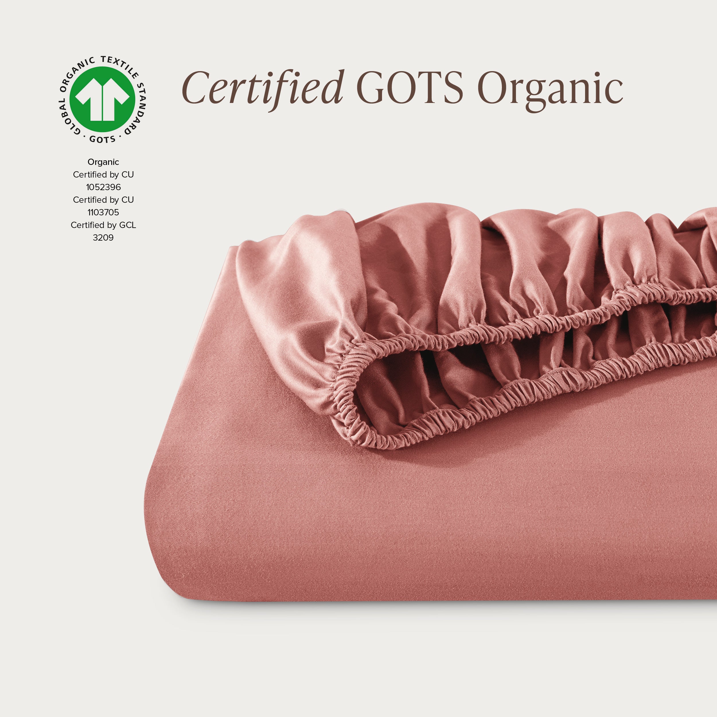 A single fitted sheet folded neatly showing part of the elastic. The fitted sheet is Certified GOTS Organic.