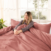 A modern bed with a sateen duvet cover set consisting of the duvet cover and two pillows.