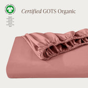A single fitted sheet folded neatly showing part of the elastic. The fitted sheet is Certified GOTS Organic.