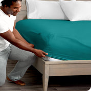 A close up of the elastic of a microfiber fitted sheet.
