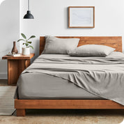 Modern bedroom with Sandwashed sheets draped over the end and side of mattress
