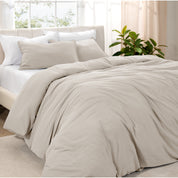 Angled view of bed with a duvet cover folded over on itself