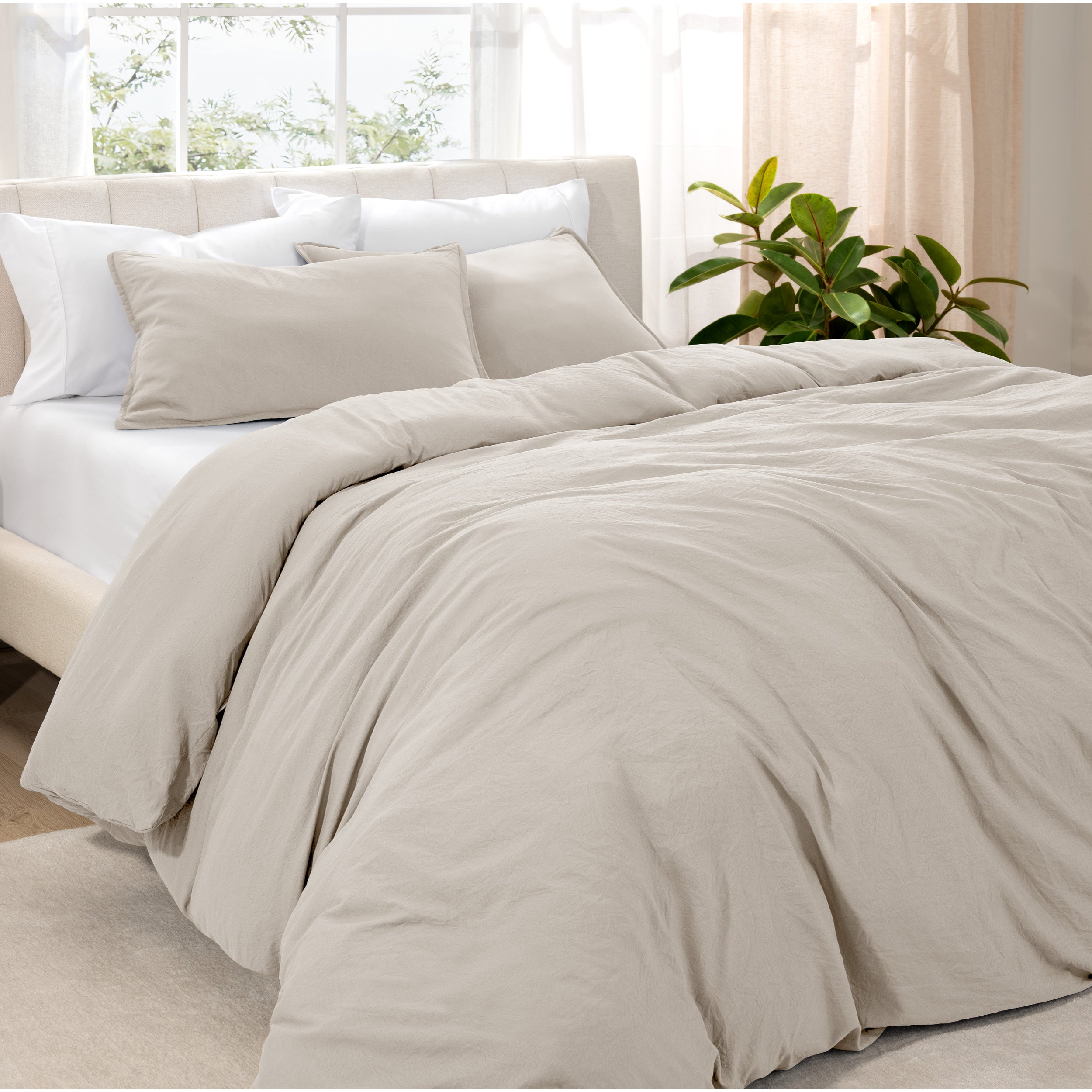 Angled view of bed with a duvet cover folded over on itself