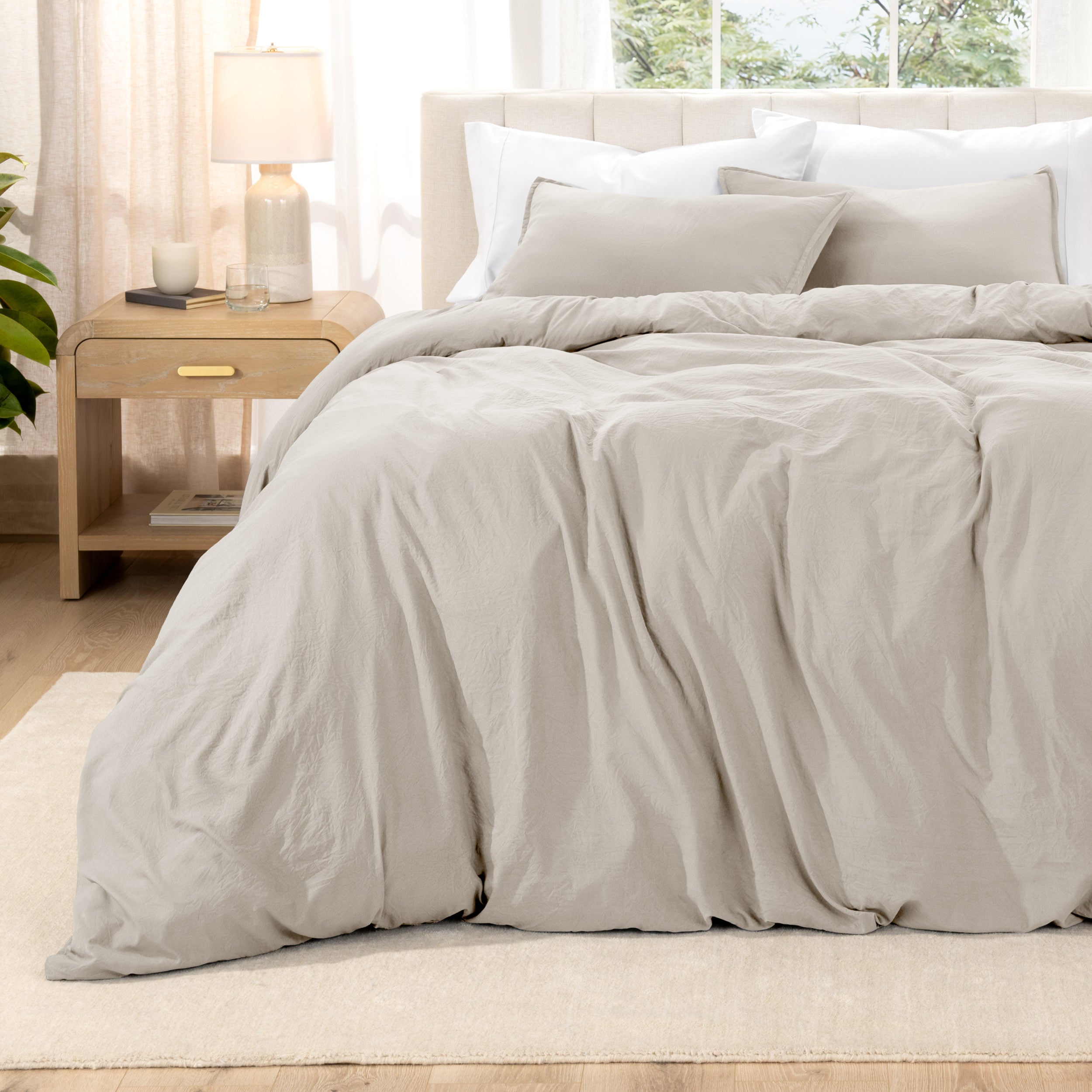 Relaxing room scene with a duvet cover laid out over the bed
