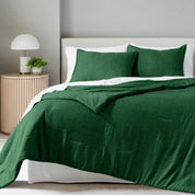 A comforter set on a bed in a bright modern room