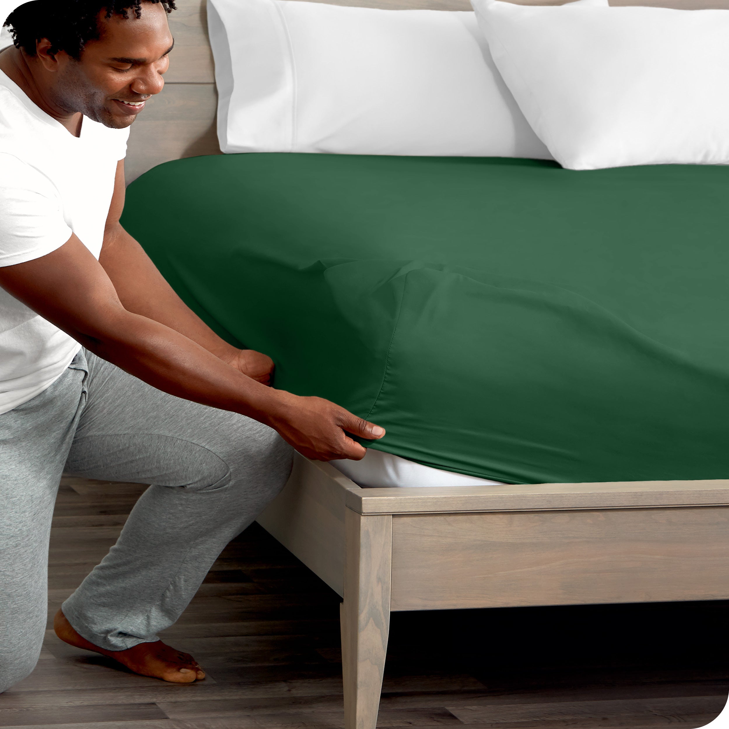 A modern bed with a fitted microfiber sheet on it