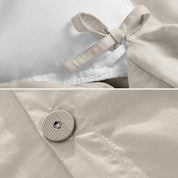 A close view of the corner tie of the duvet cover and the buttons for pillow shams