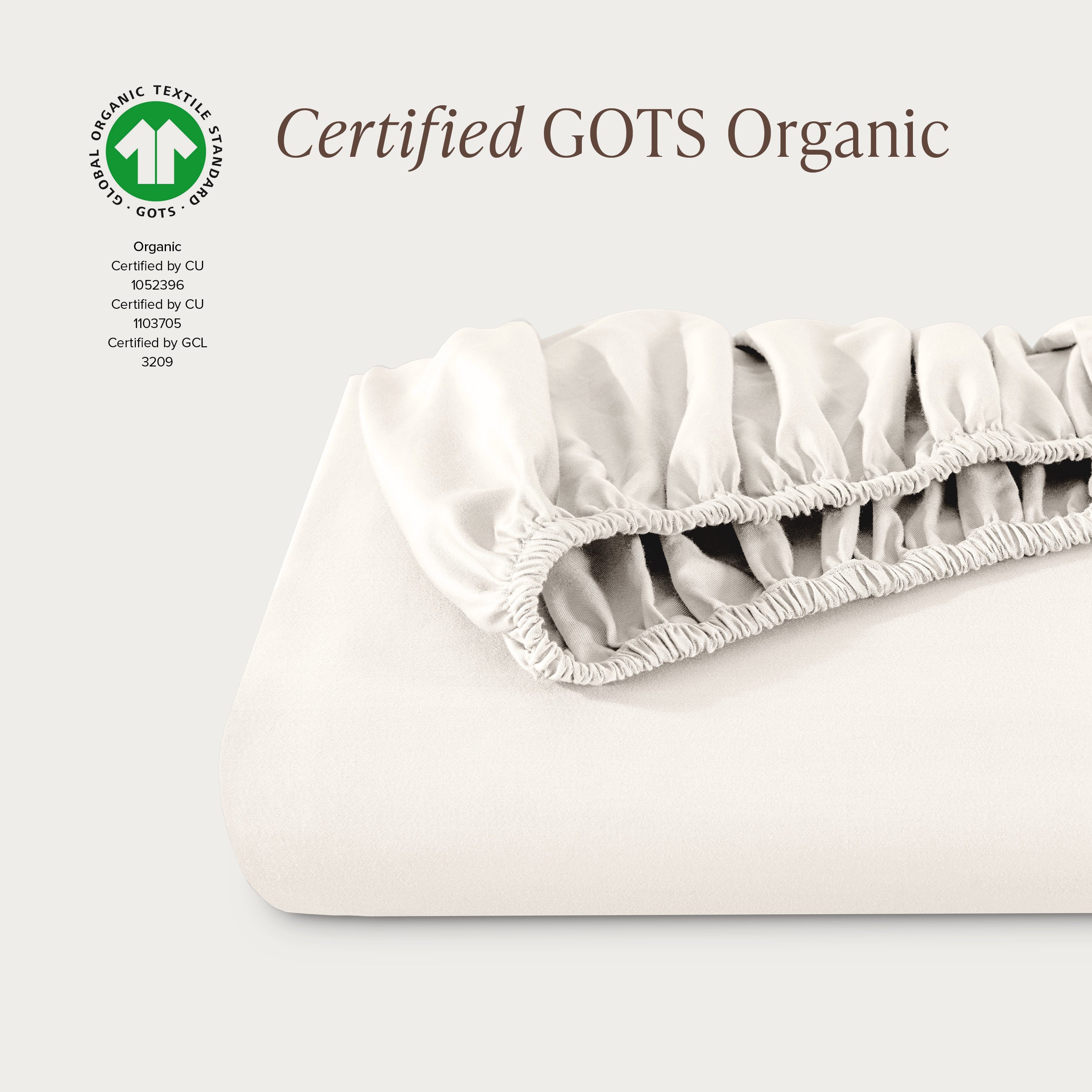 A single fitted sheet folded neatly showing part of the elastic. The fitted sheet is Certified GOTS Organic.