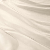Warm bright room scene showing Sateen Duvet Set  laid out over the bed