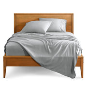 Microfiber sheet set on a bed with a wooden bed frame