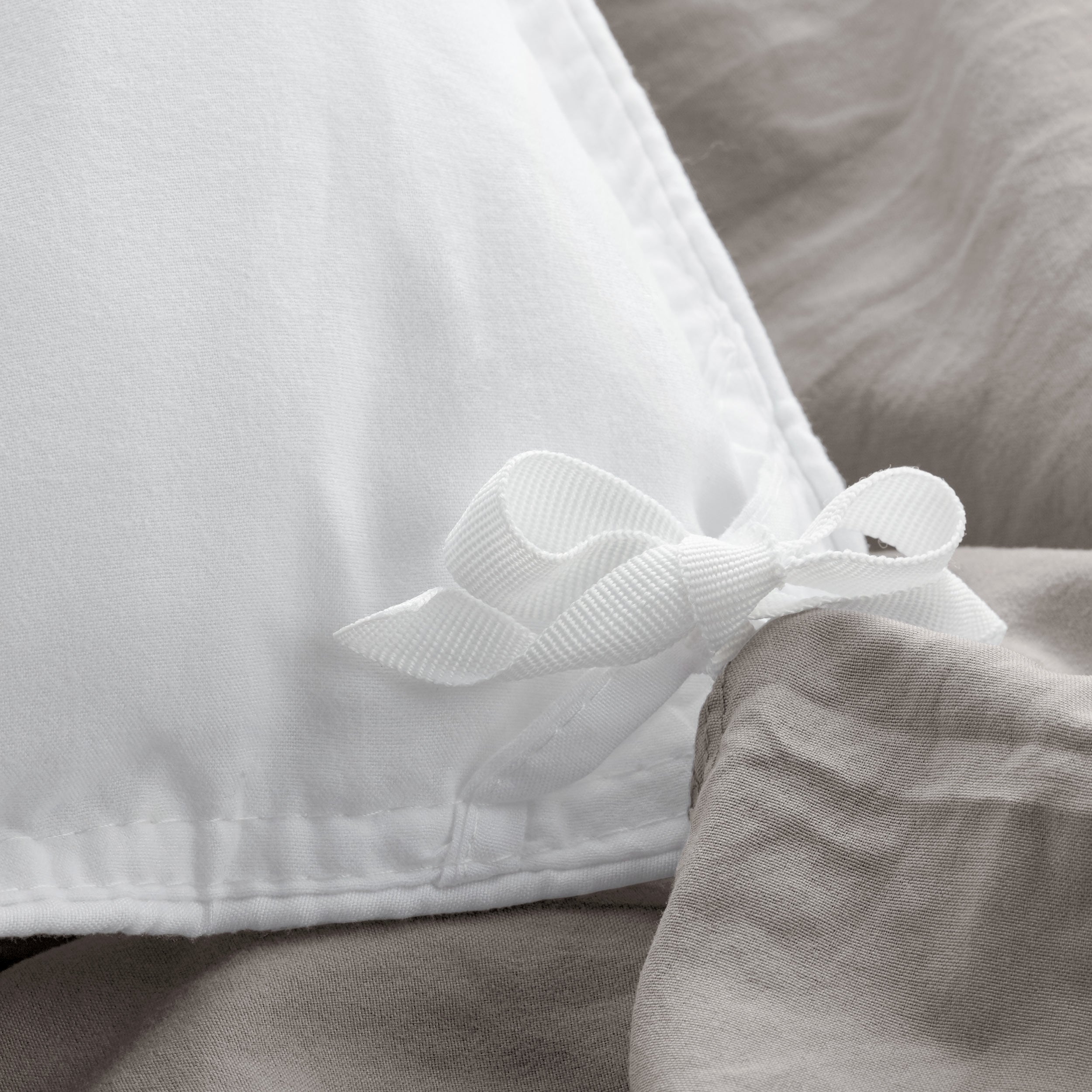 Close up of cloth ties for attaching duvet insert to inside of duvet cover