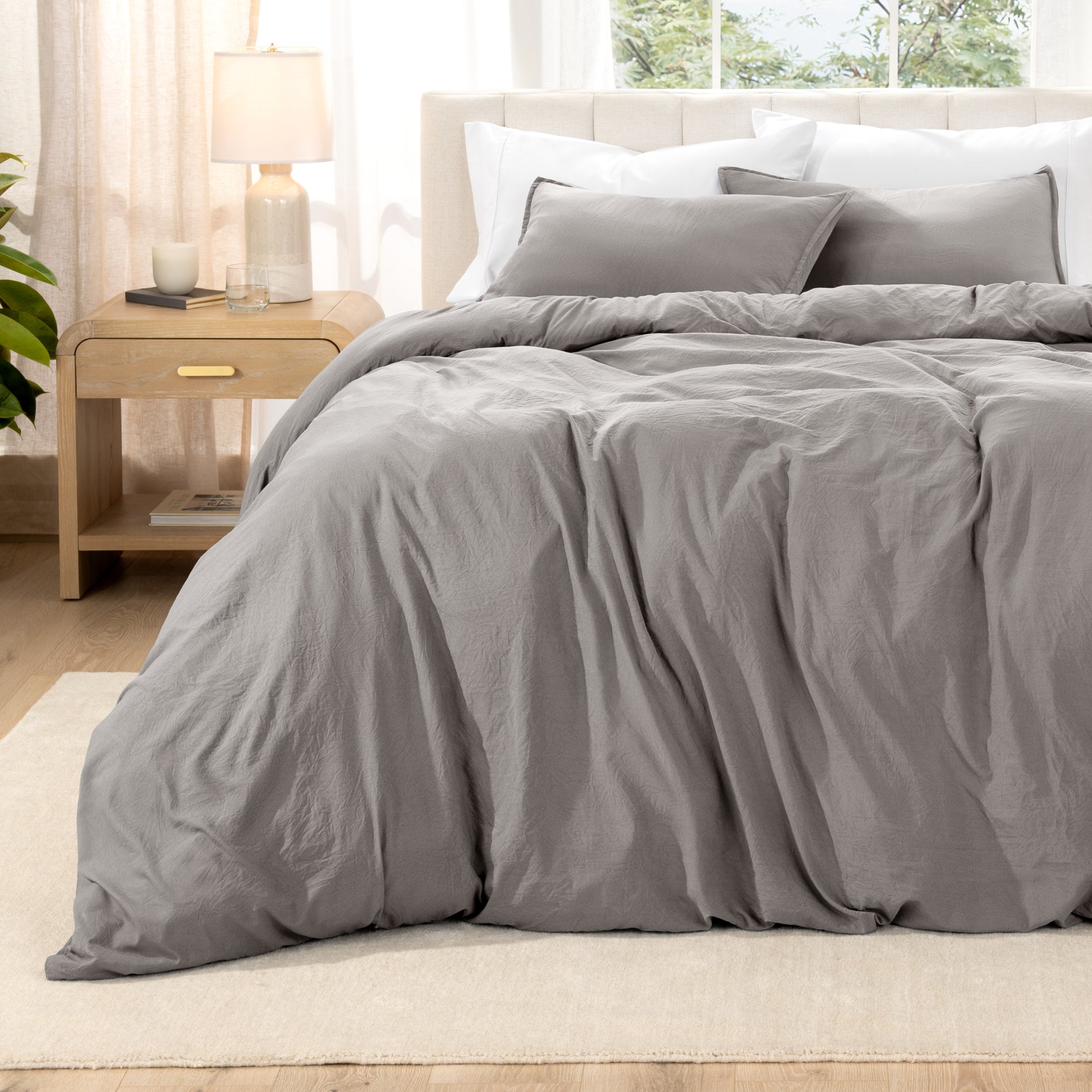 Relaxing room scene with a duvet cover laid out over the bed