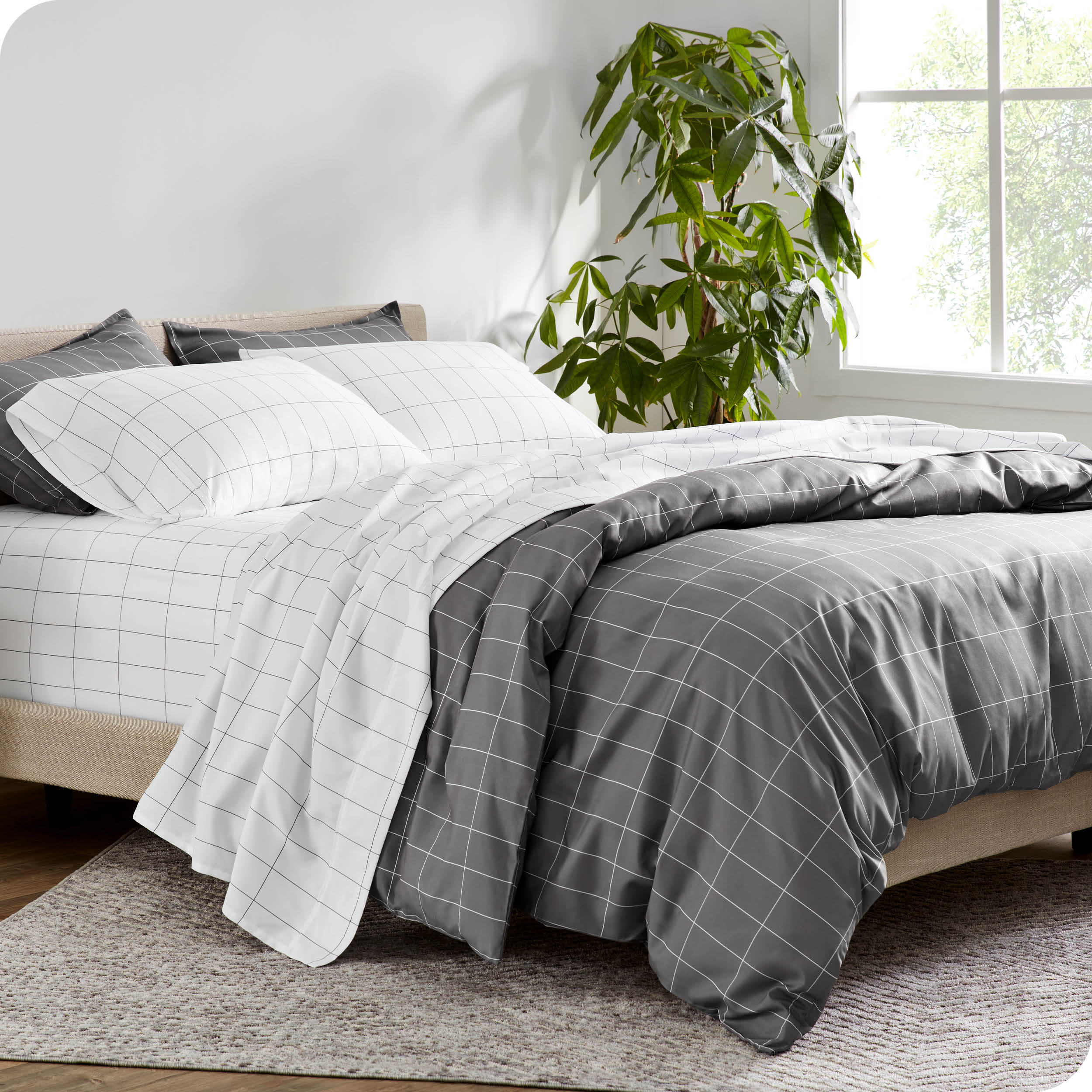 A diagonal view of a modern bed with a printed duvet cover on it.