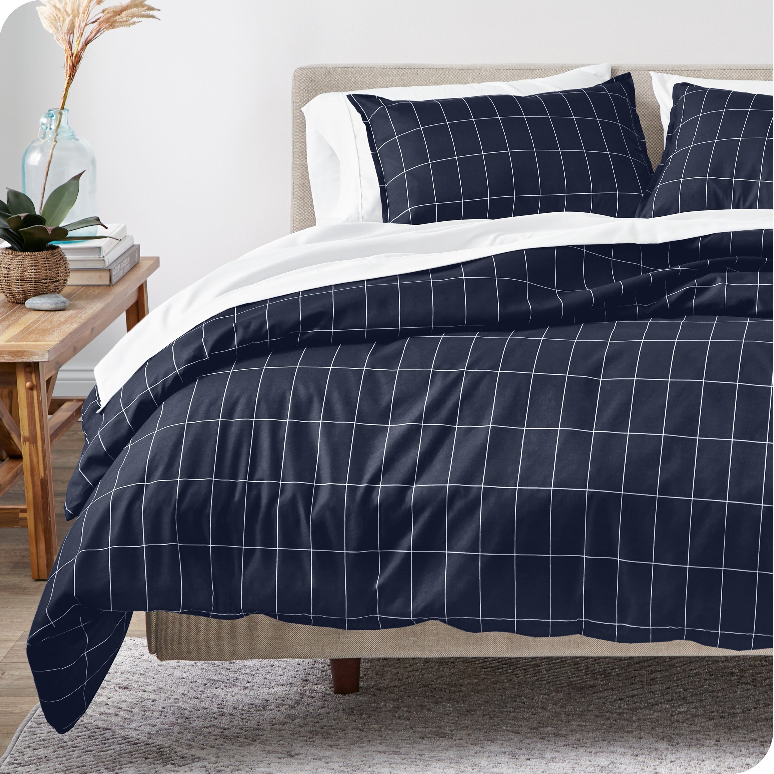 A modern bed with a grid comforter duvet set