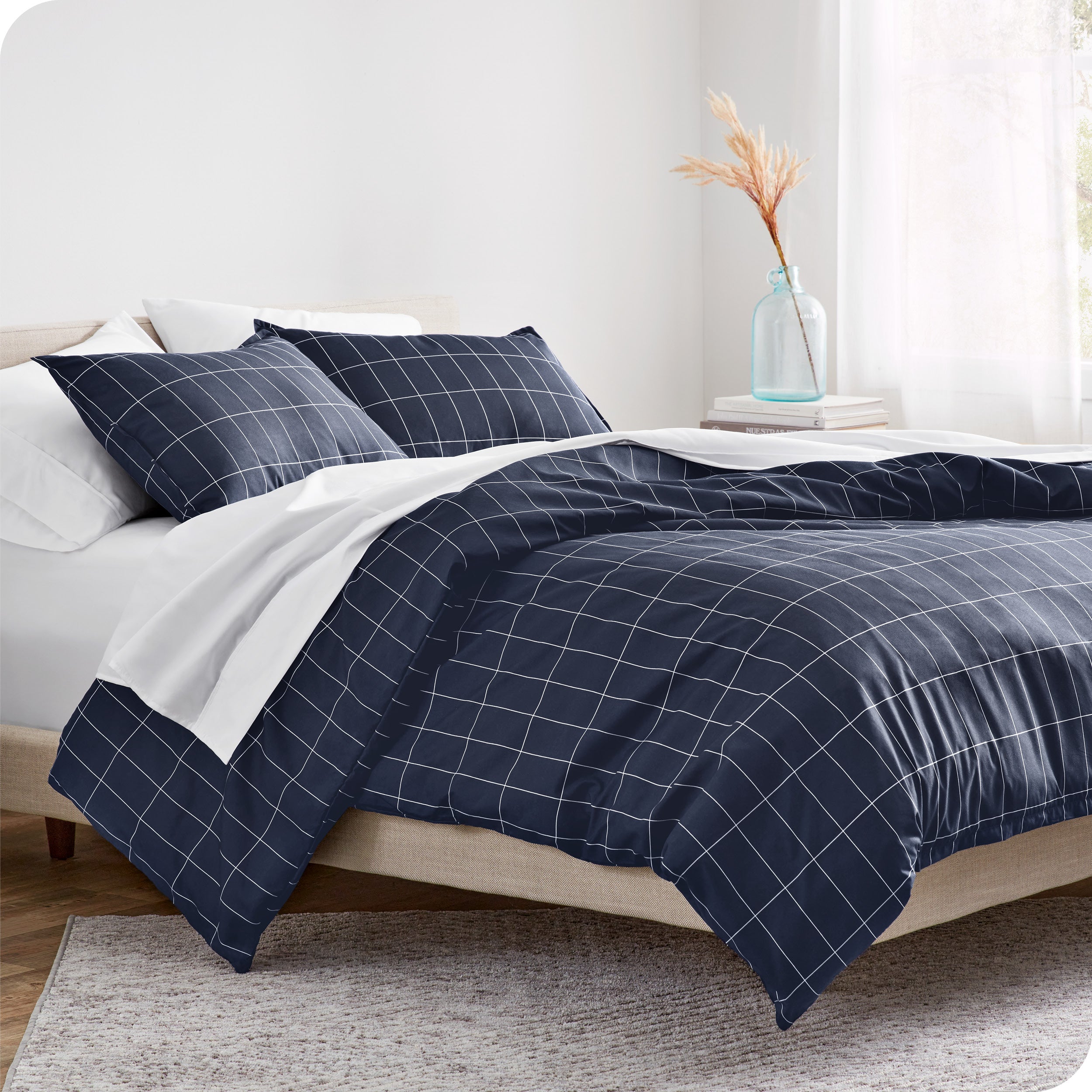 A diagonal view of a modern bed with a printed duvet cover on it.