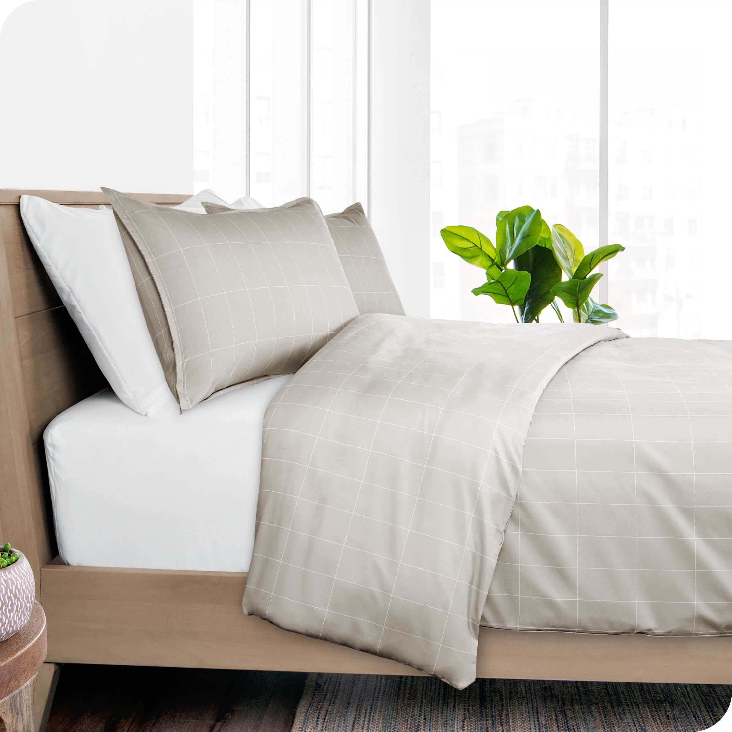 A diagonal view of a modern bed with a printed duvet cover on it.