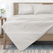 View from the end of a modern bed made with a microfiber sheet set with a modern print.
