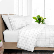 A diagonal view of a modern bed with a printed duvet cover on it.