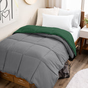 Wooden bed frame with a reversible comforter on the bed. The comforter is folded back over showing the two different colors.