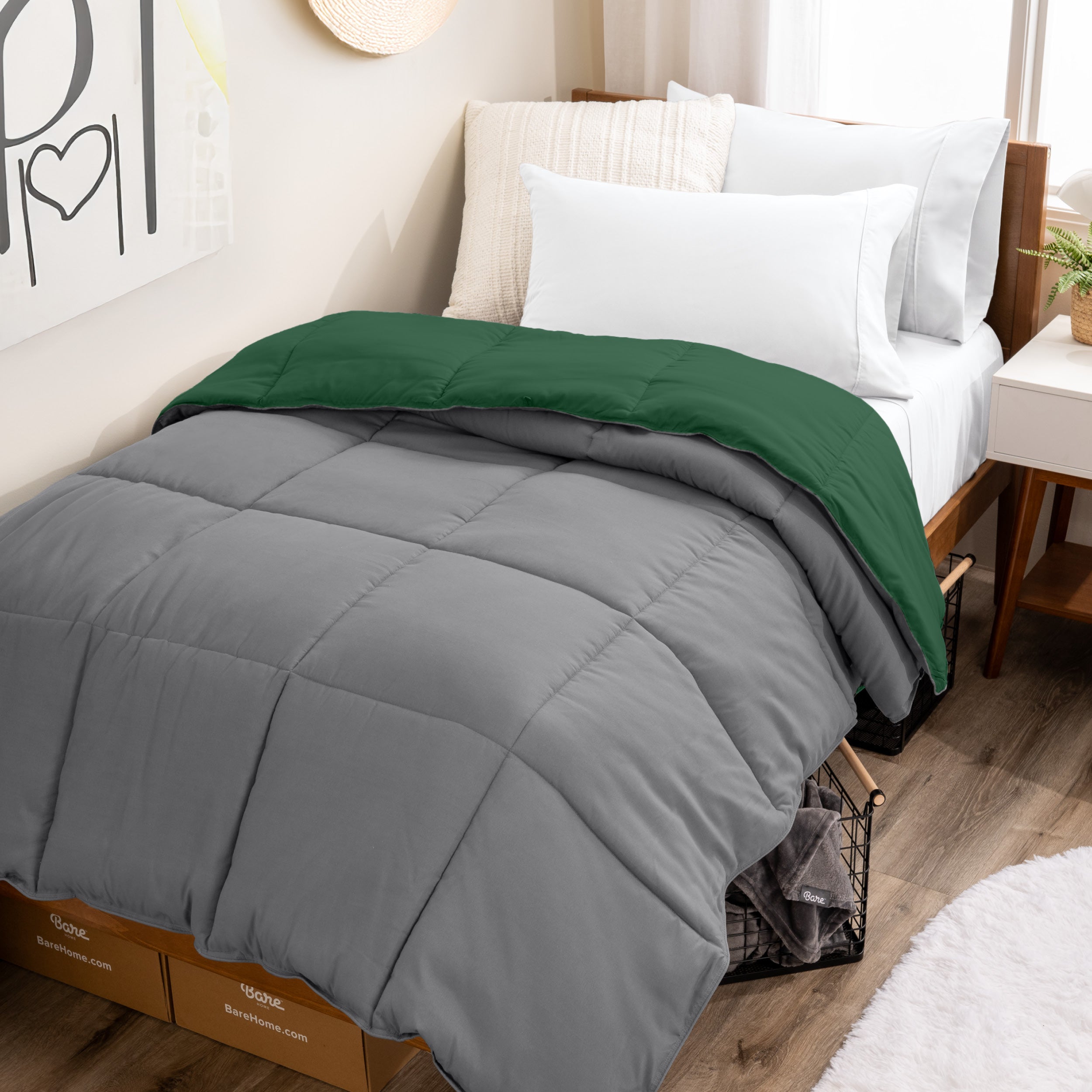 Wooden bed frame with a reversible comforter on the bed. The comforter is folded back over showing the two different colors.