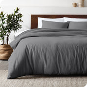 Relaxing room scene showing soft white linen duvet cover set laid out over the bed