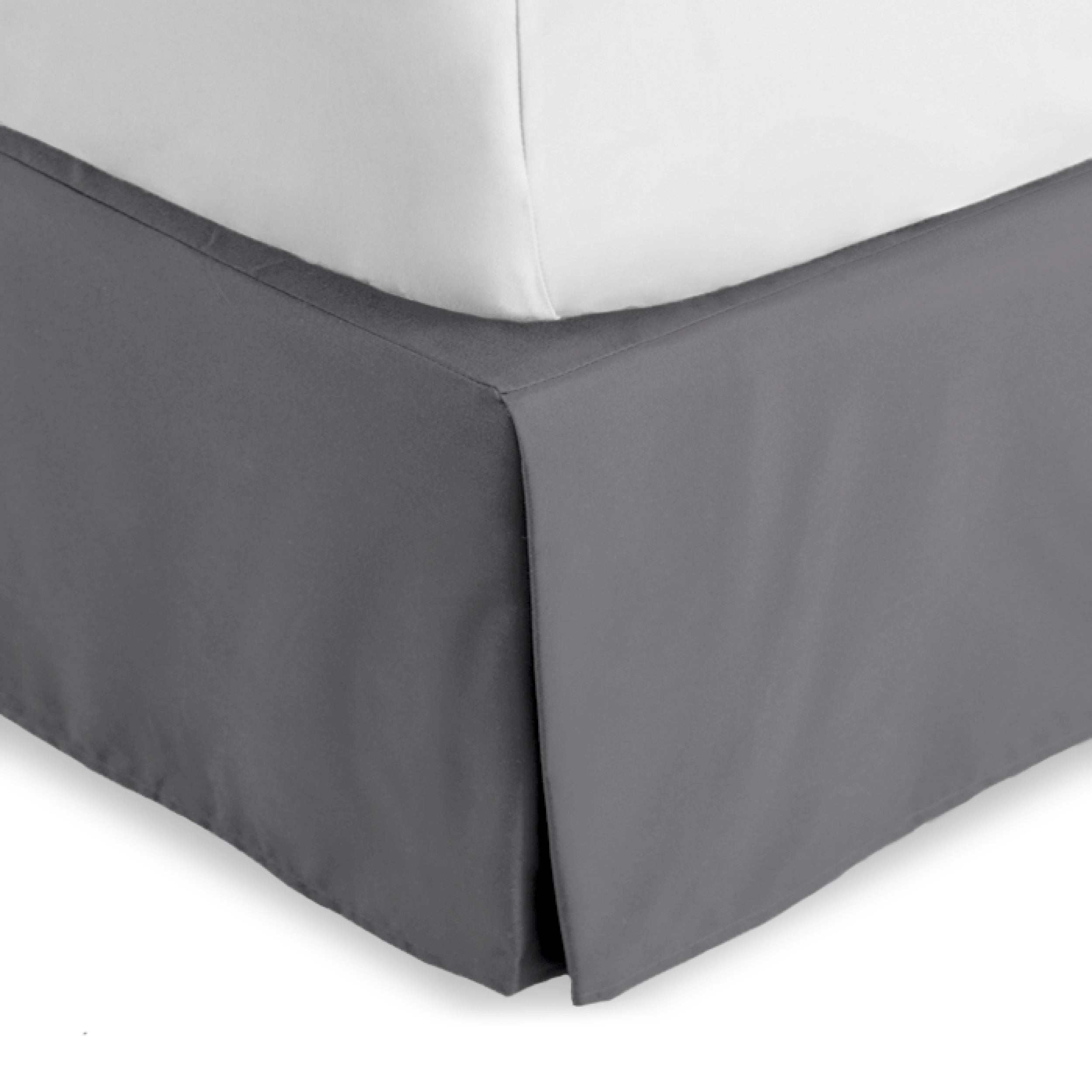 The corner of a bed skirt on a bed frame