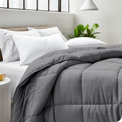 A bed made with pillows and a comforter