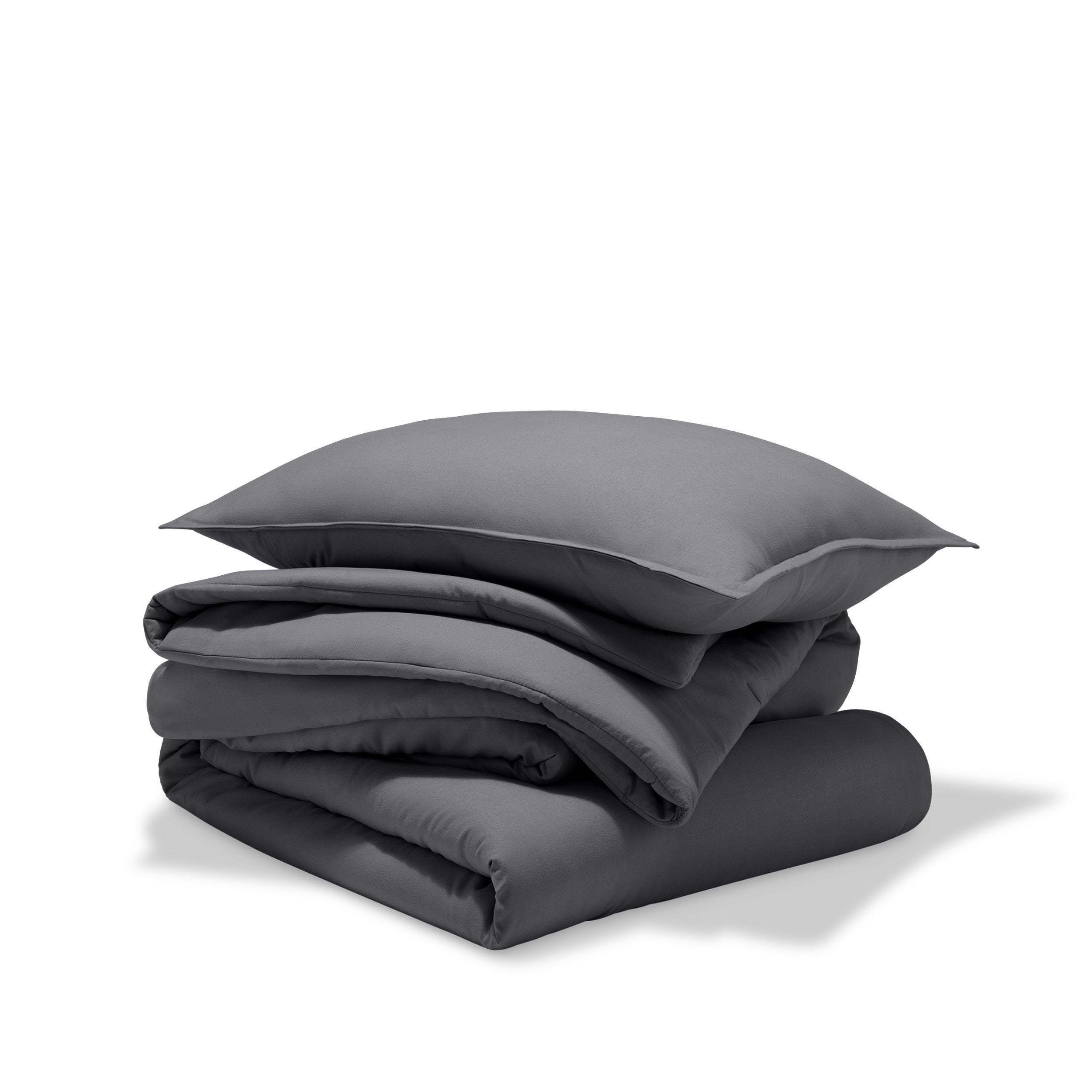 A comforter folded with a matching pillow sham stacked on top