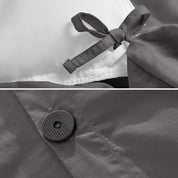 A close view of the corner tie of the duvet cover and the buttons for pillow shams