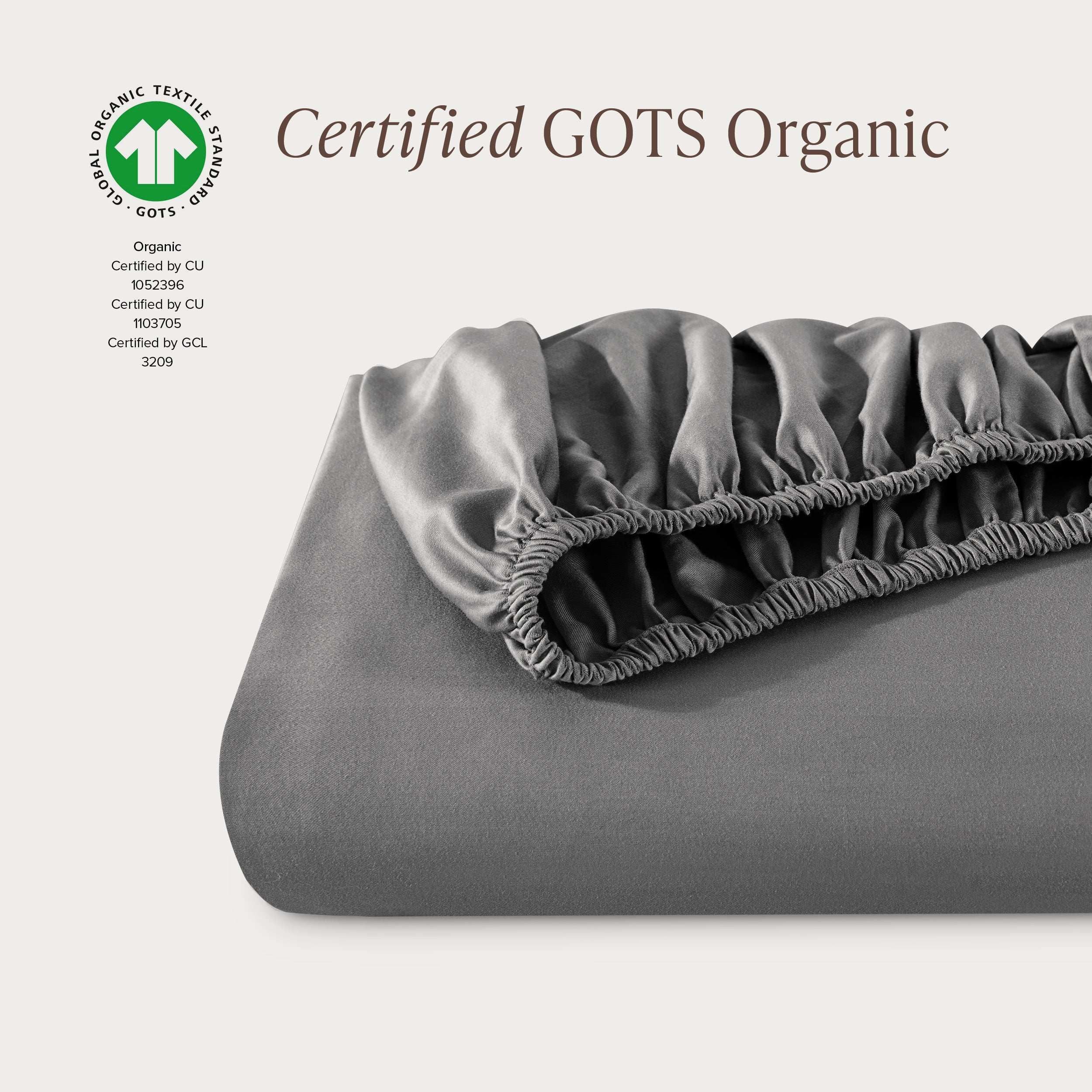 A single fitted sheet folded neatly showing part of the elastic. The fitted sheet is Certified GOTS Organic.