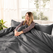 A modern bed with a sateen duvet cover set consisting of the duvet cover and two pillows.