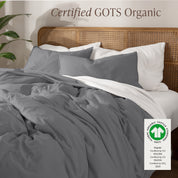 A bed made with an GOTs certified organic jersey duvet cover, pillow sham covered pillows and extra pillows