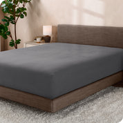 A sideview of a modern bed with a polar fleece fitted sheet on.